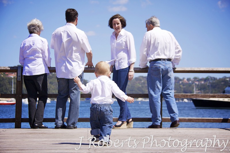 Little boy running back to his mother - family portrait photography sydney